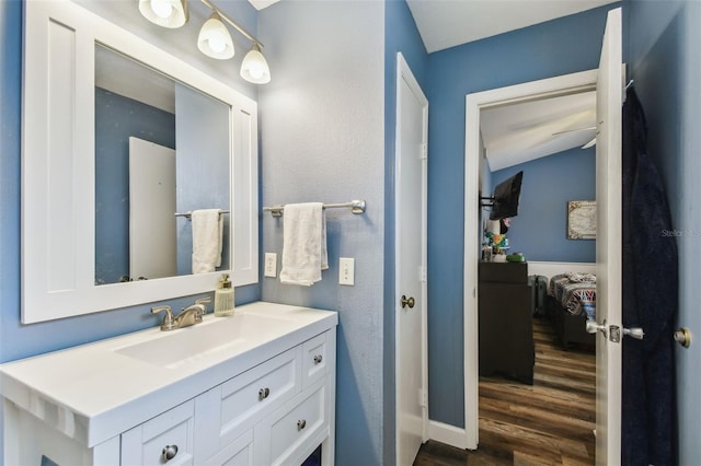 bathroom with wood finished floors and vanity