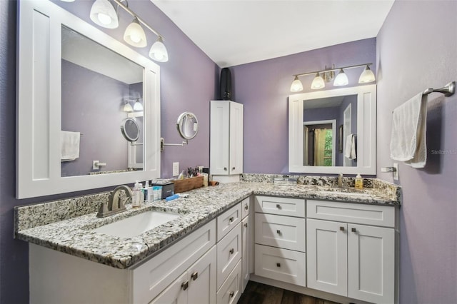 bathroom with vanity and wood finished floors