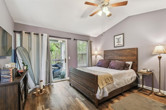 bedroom with vaulted ceiling, baseboards, wood finished floors, and access to exterior