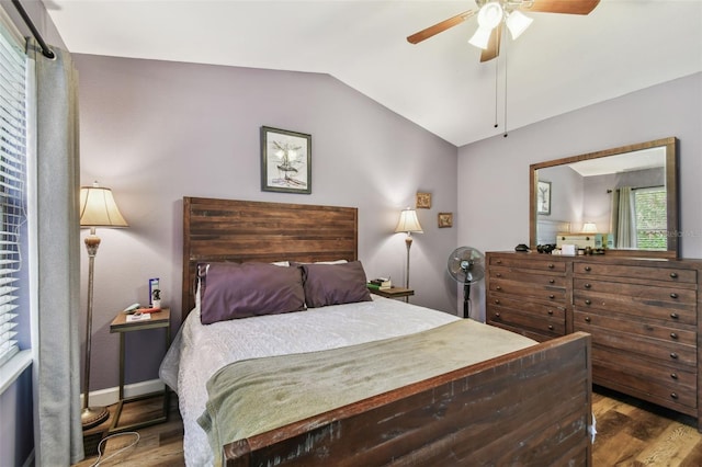 bedroom with lofted ceiling, ceiling fan, baseboards, and wood finished floors