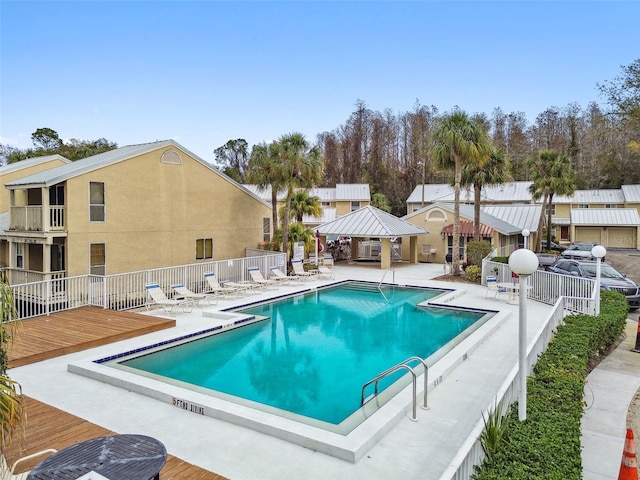 pool featuring a deck, a patio, and fence