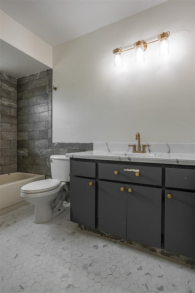 bathroom featuring toilet, vanity, and tile walls