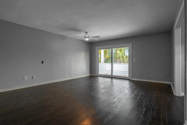 spare room featuring ceiling fan, baseboards, and dark wood-type flooring