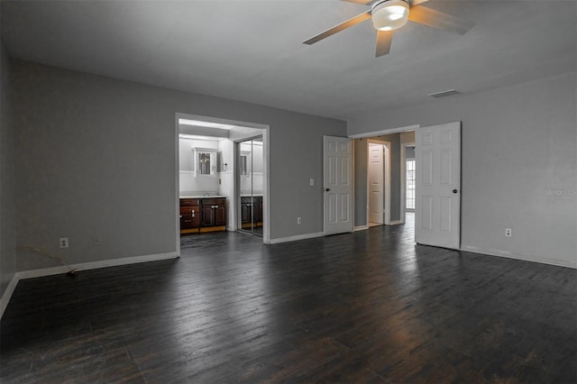 unfurnished living room with visible vents, dark wood finished floors, baseboards, and ceiling fan