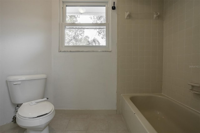 full bath with toilet, tile patterned flooring,  shower combination, and baseboards