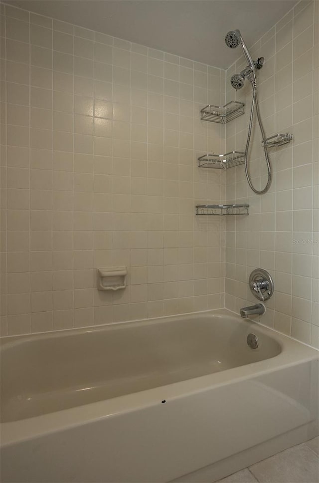 bathroom with tile patterned floors and shower / bathtub combination