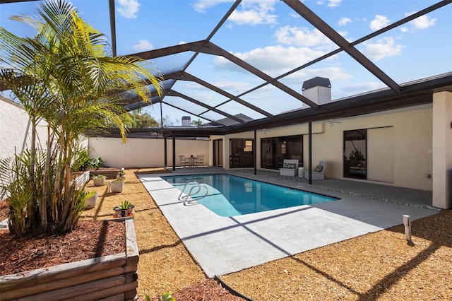 pool featuring a patio area, a lanai, and a ceiling fan