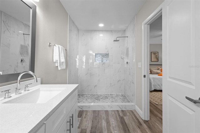 full bathroom featuring a marble finish shower, ensuite bath, wood finished floors, vanity, and recessed lighting