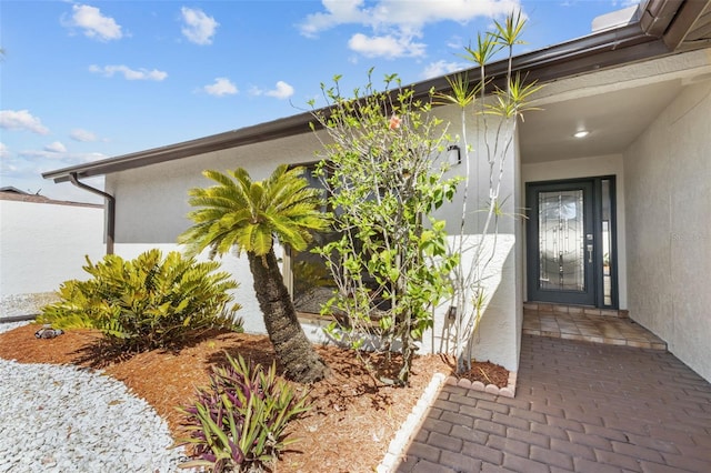 property entrance featuring stucco siding