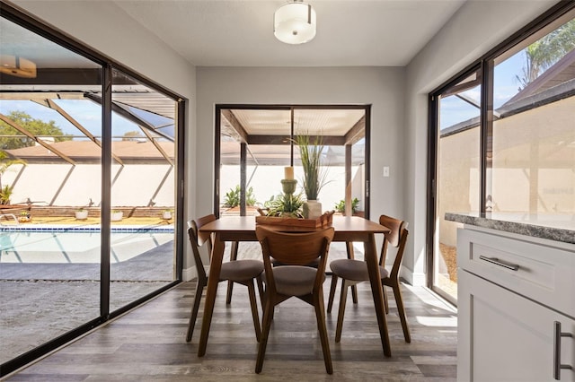 dining area with baseboards and dark wood-style flooring