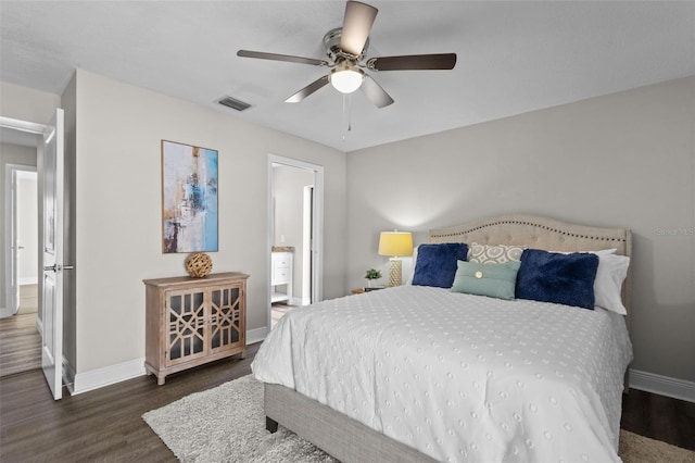 bedroom with ceiling fan, wood finished floors, visible vents, baseboards, and ensuite bath