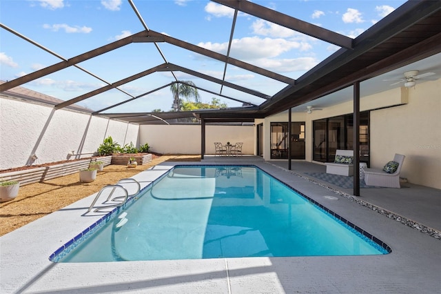 outdoor pool with a patio, glass enclosure, and a ceiling fan