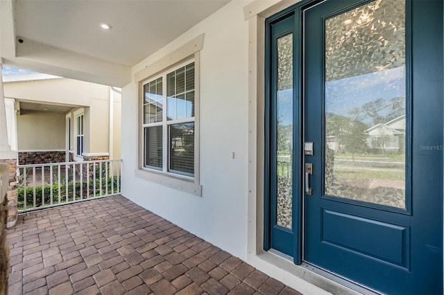 property entrance with stucco siding