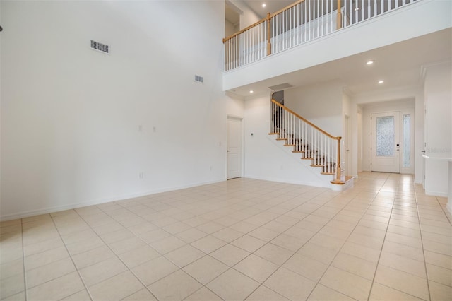 unfurnished living room with recessed lighting, visible vents, stairway, and baseboards