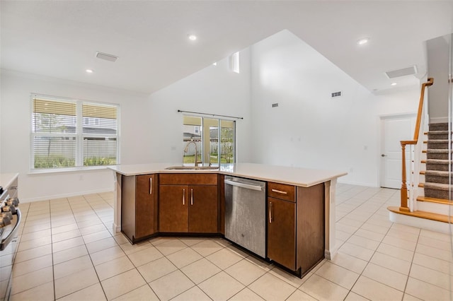 kitchen featuring light countertops, stainless steel dishwasher, a sink, and a kitchen island with sink