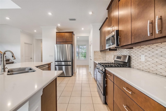 kitchen featuring appliances with stainless steel finishes, light countertops, a sink, and visible vents