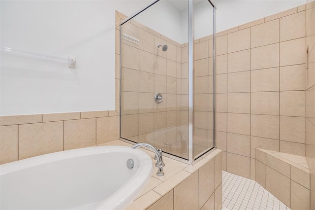 full bathroom featuring tiled shower and a bath