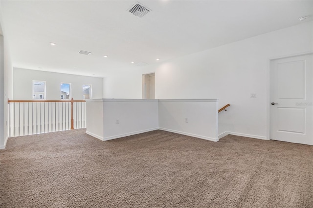 carpeted spare room with baseboards, visible vents, and recessed lighting