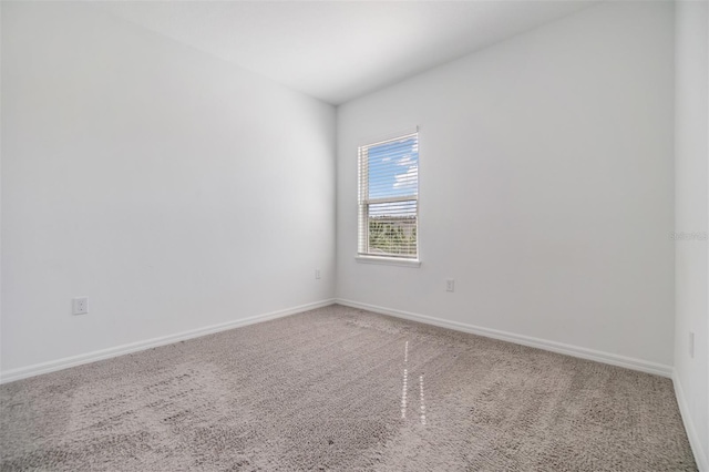 carpeted spare room with baseboards