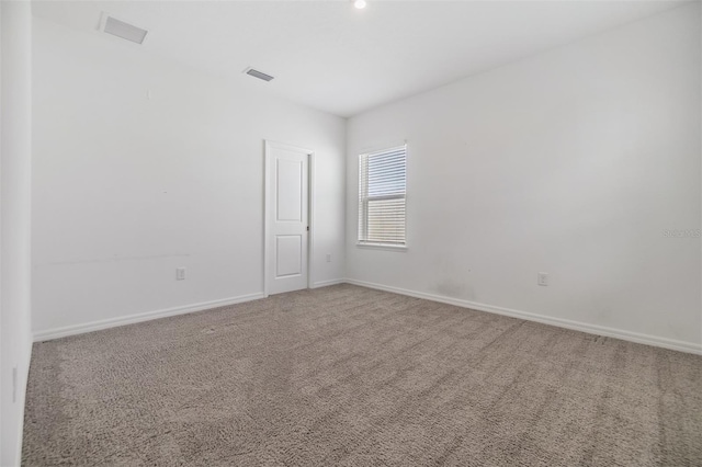 unfurnished room featuring baseboards and carpet flooring