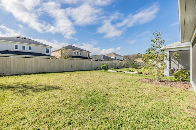 view of yard with a fenced backyard and a residential view