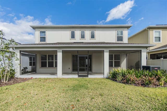 back of property with a patio area, stucco siding, and a yard