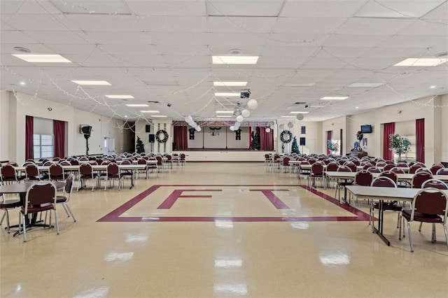 interior space with a paneled ceiling