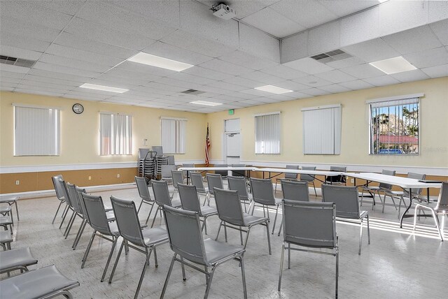 misc room featuring baseboards, visible vents, and a drop ceiling