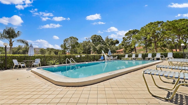 pool featuring a patio area and fence