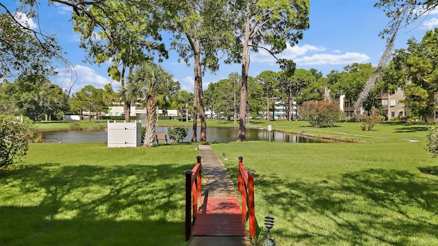 view of home's community with a yard and a water view