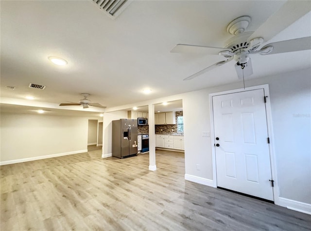 unfurnished living room with a ceiling fan, visible vents, light wood-style flooring, and baseboards