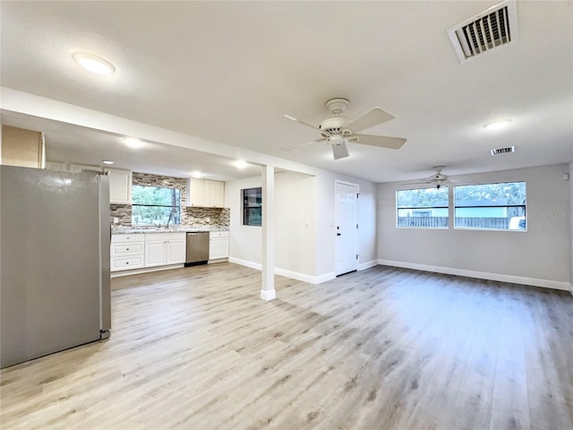 11201 Blendale Dr, Riverview, FL 33569 - unfurnished living room with light wood-type flooring, visible vents, and baseboards