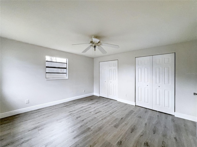 11201 Blendale Dr, Riverview, FL 33569 - unfurnished bedroom with ceiling fan, baseboards, multiple closets, and wood finished floors