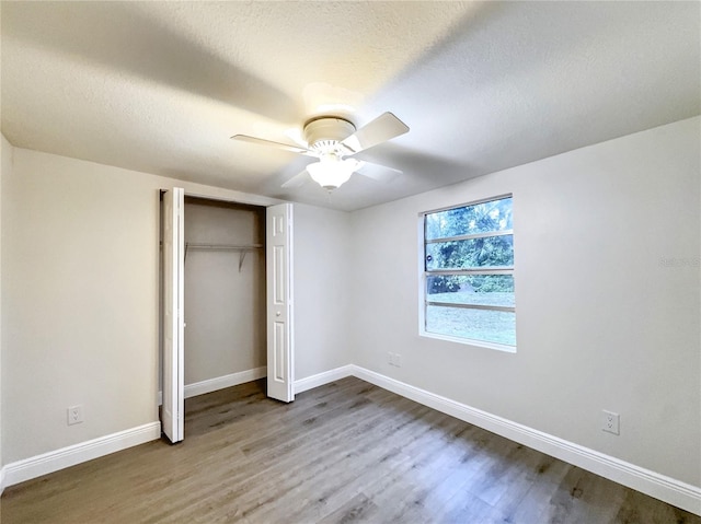 11201 Blendale Dr, Riverview, FL 33569 - unfurnished bedroom featuring a closet, a textured ceiling, baseboards, and wood finished floors