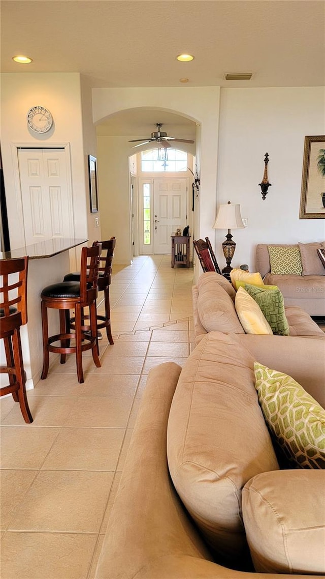 living room featuring a ceiling fan and recessed lighting