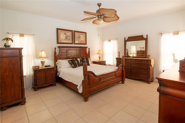 bedroom with ceiling fan and light tile patterned floors