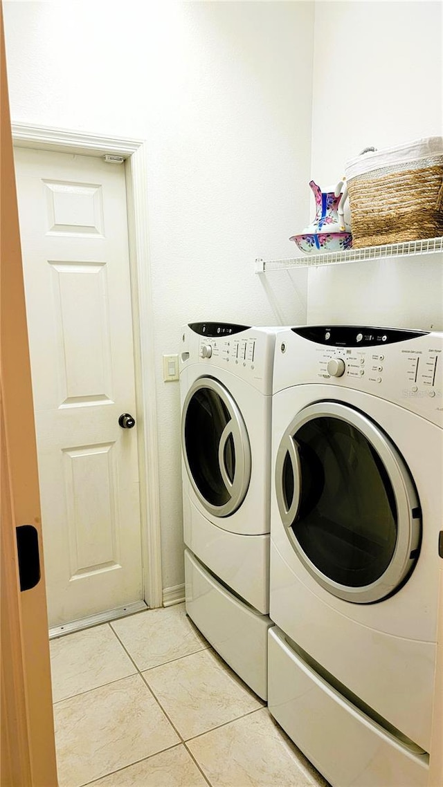 laundry room featuring laundry area, light tile patterned flooring, and washer and dryer