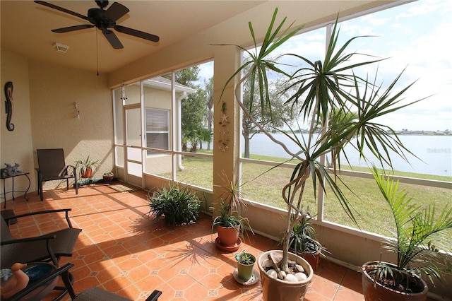 sunroom / solarium featuring ceiling fan, a water view, and visible vents