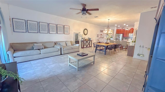 living room with light tile patterned floors and ceiling fan with notable chandelier