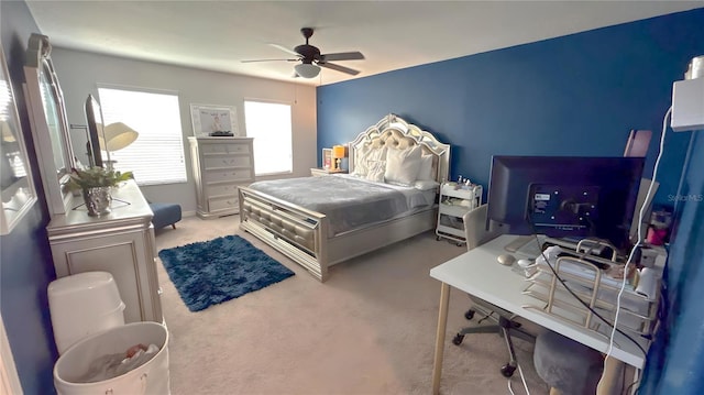 bedroom featuring light carpet and a ceiling fan