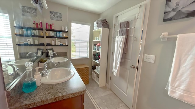 full bathroom featuring double vanity, a sink, and tile patterned floors