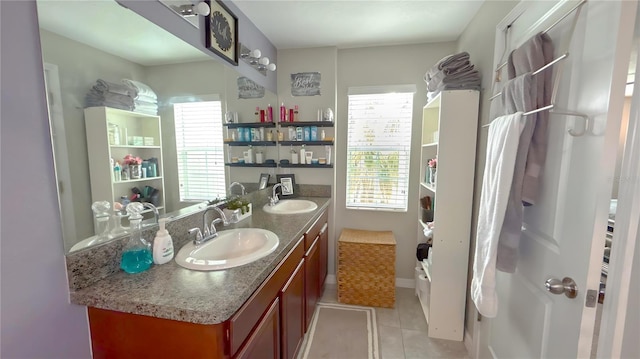 bathroom featuring double vanity, tile patterned flooring, and a sink