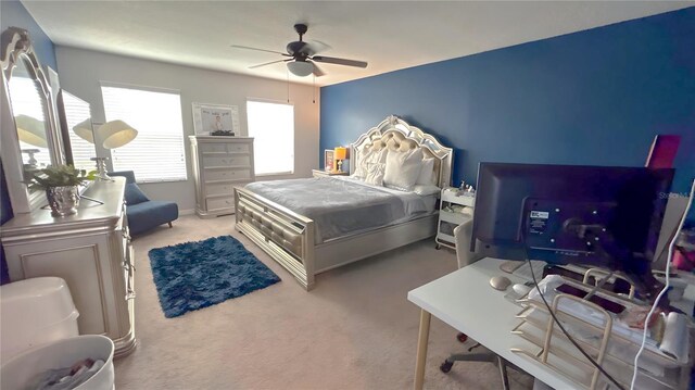 bedroom featuring a ceiling fan and light colored carpet