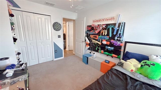 bedroom featuring light carpet, a closet, and visible vents