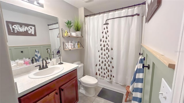 bathroom with toilet, tile patterned flooring, shower / bath combination with curtain, and vanity