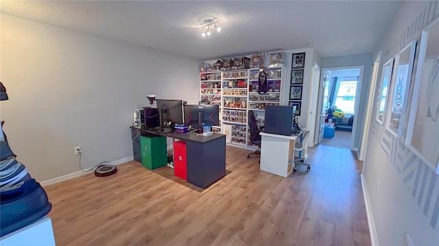 home office with wood finished floors and baseboards