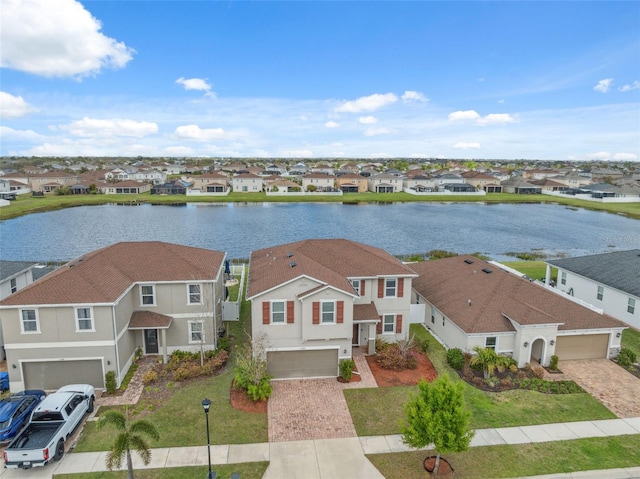 birds eye view of property featuring a water view and a residential view