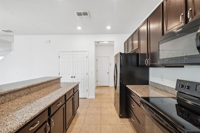 kitchen featuring light tile patterned floors, visible vents, dark brown cabinets, light stone countertops, and black appliances