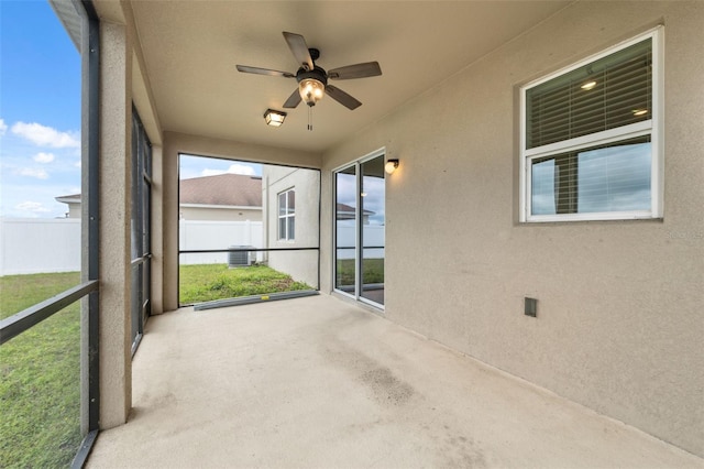 unfurnished sunroom featuring a ceiling fan