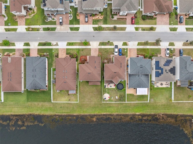 drone / aerial view featuring a water view and a residential view